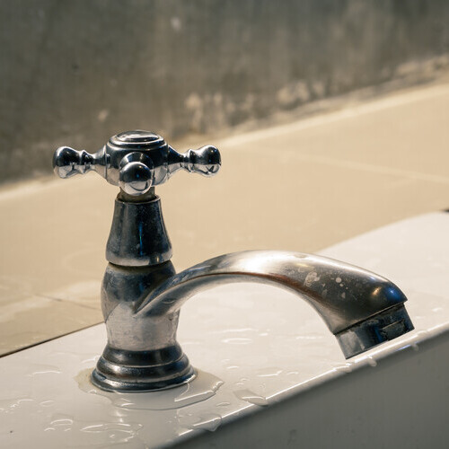 close-up of a faucet on the side of a sink