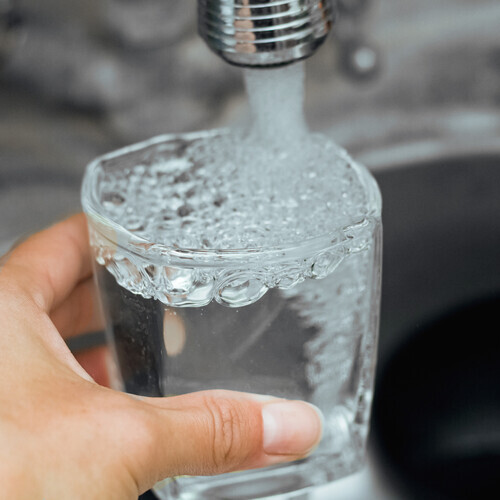 pouring water into a glass